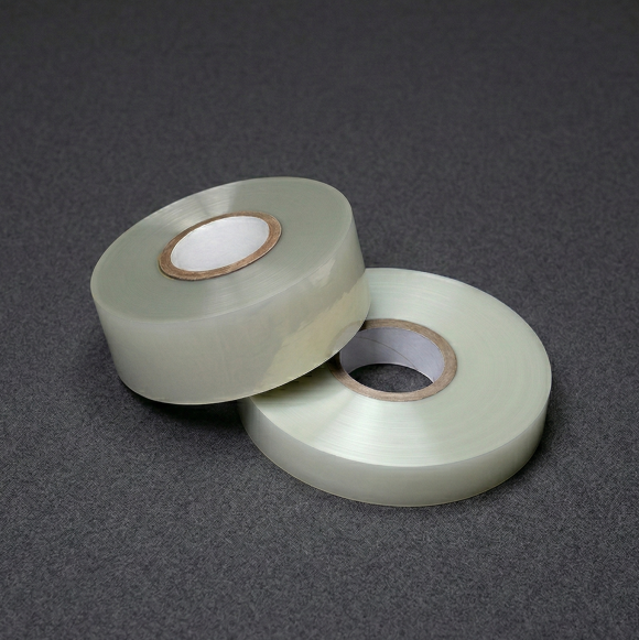 Two rolls of translucent heat-shrinkable tape on cardboard cores