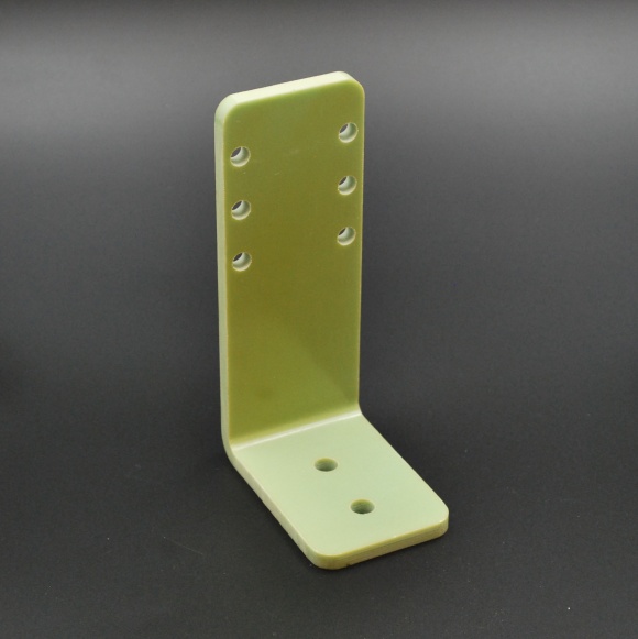 Molded L-shaped bracket in light green glass-fibre composite with drilled holes