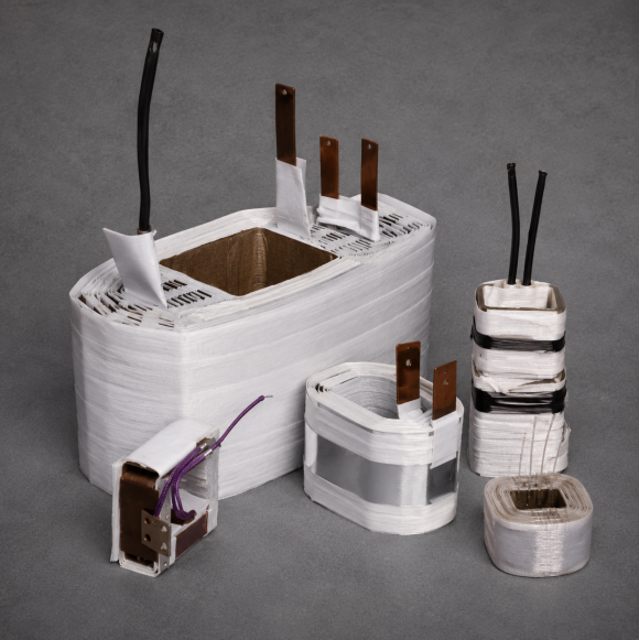 Coils wrapped in white insulating tape, with copper terminals and lead wires