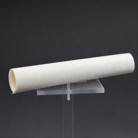 AraShield&trade; - a rolled sheet of white aramid electrical insulation paper on a clear display stand.