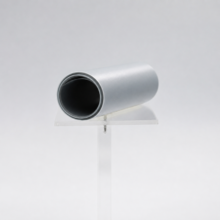 Nomsite-Preg&trade; - a metallic-gray roll of prepreg electrical insulation material on a clear display stand.